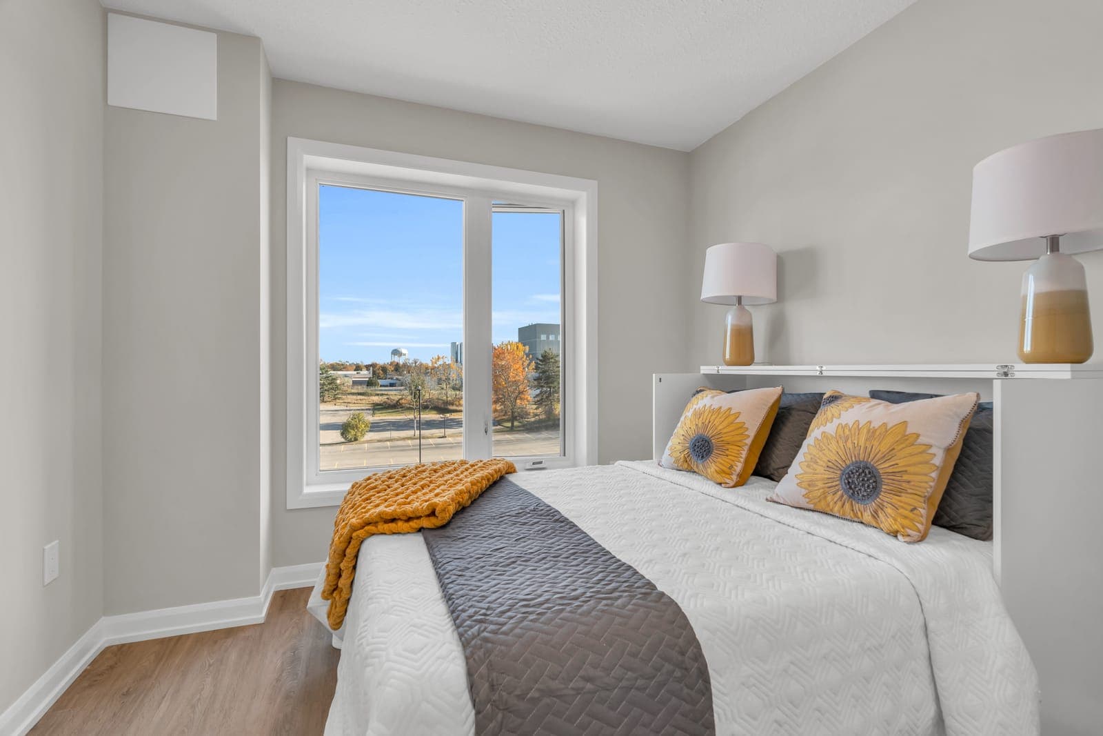 Bedroom in the Platinum model home with a glass door to a balcony.