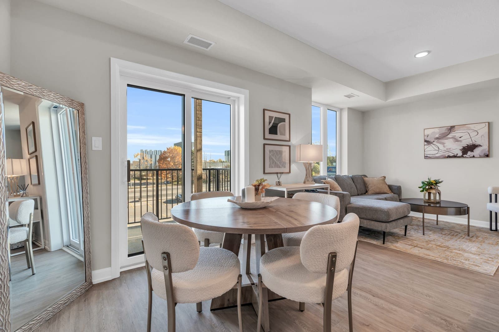 Dining area of the Platinum model home beside a glass door to the balcony.